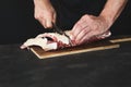 Chef cutting rack of lamb on wooden board Royalty Free Stock Photo