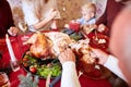 Man cutting roasted turkey on a table background. Family enjoying autumn holidays. Thanksgiving dinner concept. Royalty Free Stock Photo