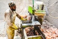 A man cutting rock salt to make tiles & bricks