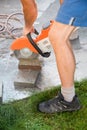 Man cutting stone tiles with a circular saw. vertical Royalty Free Stock Photo