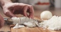 Man cutting white onion with knife Royalty Free Stock Photo