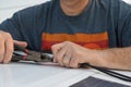 Man cutting a wire tie for a solar panel connection on a recreational vehicle. Royalty Free Stock Photo