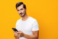 Man smartphone smiling studio happy cyberspace space phone phone portrait communication mobile copy yellow Royalty Free Stock Photo