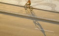 Man cycling along the wave pattern sidewalk of Portuguese pavement, Copacabana beach, Brazil Royalty Free Stock Photo