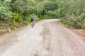 Man is cycling on the dirt road in Honduras Royalty Free Stock Photo