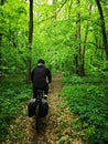 Man cycling in the green forest