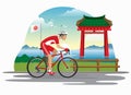 Man cycling in japan with japanese gate as bakcground