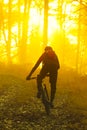 Man cycling with mountain bike at sunrise or sunset