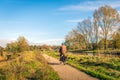 Man cycling on a narrow cycle path along the water