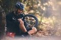 Man, cycling and outdoor with leg or knee injury in nature for sports, exercise or training on mountain bike. Athlete Royalty Free Stock Photo