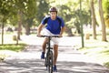 Man Cycling Through Park Royalty Free Stock Photo