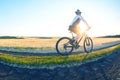 man cyclist rides a bike on a road in nature. sports, cycling and health hobbies Royalty Free Stock Photo