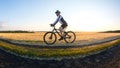 man cyclist rides a bike on a road in nature. sports, cycling and health hobbies Royalty Free Stock Photo