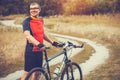 Man cyclist rides in the forest on a mountain bike. Royalty Free Stock Photo