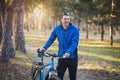 Man cyclist rides in the forest on a mountain bike. Royalty Free Stock Photo