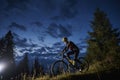 Cheerful male cyclist riding bicycle at night. Royalty Free Stock Photo