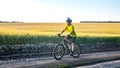 man cyclist in yellow clothes rides a bike on a road in nature. sports, hobbies and entertainment for health Royalty Free Stock Photo