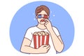 Man in 3D glasses eating popcorn