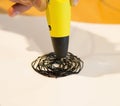 Man 3d pen draws a circle on white paper