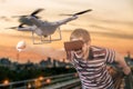 Man with 3D virtual reality glasses is controlling a flying drone Royalty Free Stock Photo