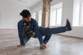 Man dancer in a fashionable blue denim jacket and jeans dancing