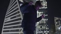 Man dances on background of skyscrapers. Action. Young man is dancing coolly on background of night city. Guy dances in Royalty Free Stock Photo