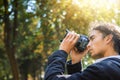 Man with dark brown curly hair in central park Royalty Free Stock Photo