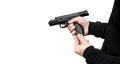 A man in dark clothes holds a pistol in his hands and reloads it. Unloaded weapon in hand