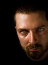 Man in the dark with evil eyes Royalty Free Stock Photo