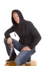 Man in dark hoodie hold gun looking Royalty Free Stock Photo