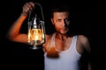 Man in the dark with a kerosene lamp