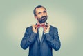 Man in dark suit,  blue shirt, adjusting red butterfly bow, tie Royalty Free Stock Photo