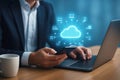Man in suit using smartphone and laptop with glowing cloud technology network cloud computing data Royalty Free Stock Photo