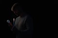 man in darkness holding lit candle Royalty Free Stock Photo