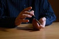 Man in darkness holding a set of playing cards and shuffle them, business strategic competition concept Royalty Free Stock Photo