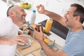 man daubing partner with chocolate spread at breakfast Royalty Free Stock Photo