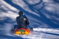 Man with daughter sledding down a snowy hill Royalty Free Stock Photo