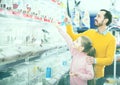 Man and daughter are studying a variety of birds
