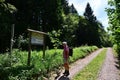 Man with daypack and little dog takes notice of an information board Royalty Free Stock Photo