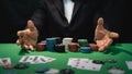 Man dealer or croupier shuffles poker cards in a casino on the background of a table,asain man holding two playing cards. Royalty Free Stock Photo