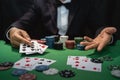 Man dealer or croupier shuffles poker cards in a casino on the background of a table, poker game concept Royalty Free Stock Photo