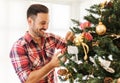 Man decorating a Christmas tree Royalty Free Stock Photo
