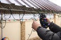 Man decorating house with Christmas lights outdoors, closeup Royalty Free Stock Photo