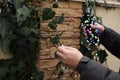 Man decorating house with Christmas lights outdoors, closeup Royalty Free Stock Photo
