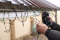 Man decorating house with Christmas lights outdoors, closeup Royalty Free Stock Photo