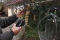 Man decorating house with Christmas lights outdoors, closeup Royalty Free Stock Photo