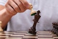 Man Defeating King Chess Piece With Pawn