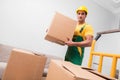 The man delivering boxes during house move Royalty Free Stock Photo