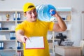 The man delivering water bottle to the office