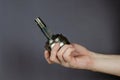 A man demonstrates a Drive shaft joint against a gray background. New Constant velocity joints